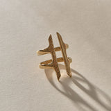 Akash Shield Statement Ring in solid recycled gold at an angle, showing the carved shield bars and open design.