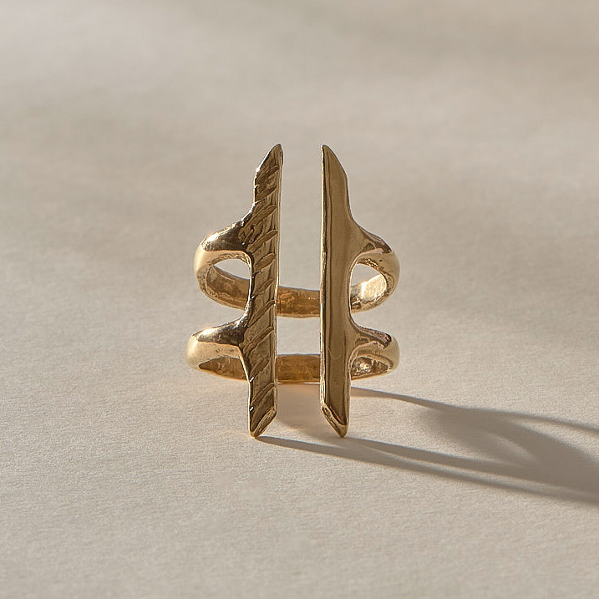 Akash Shield Statement Ring in solid recycled gold from the front, two carved bars joined by a double band.