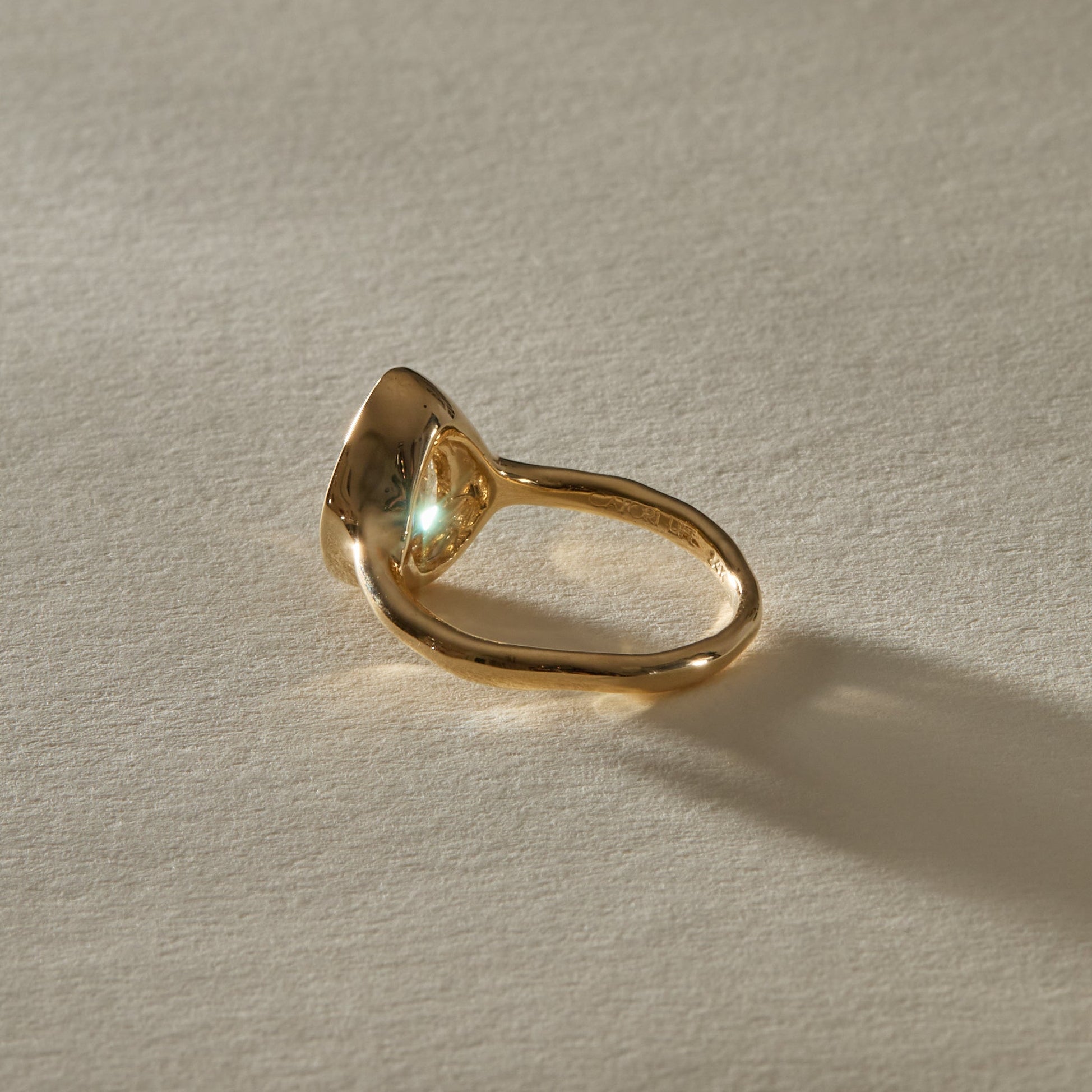 Aurum Pear Diamond Ring from the side at a low angle.