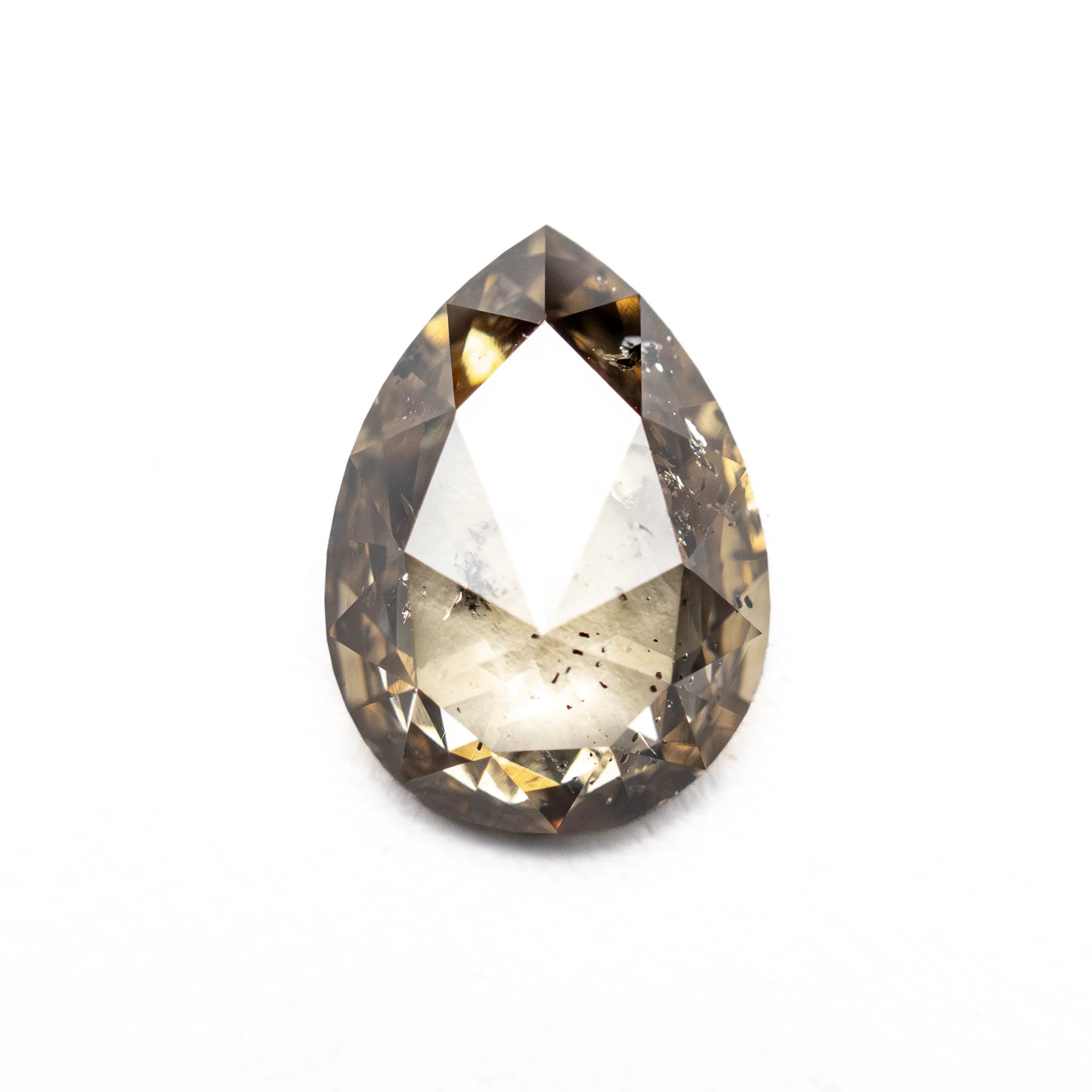 Close up of the champagne salt and pepper pear rose cut diamond showing its natural inclusions.