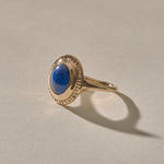 Cleo Lapis Lazuli Amulet Ring in gold at an angle, showing the lapis stone and slim band.
