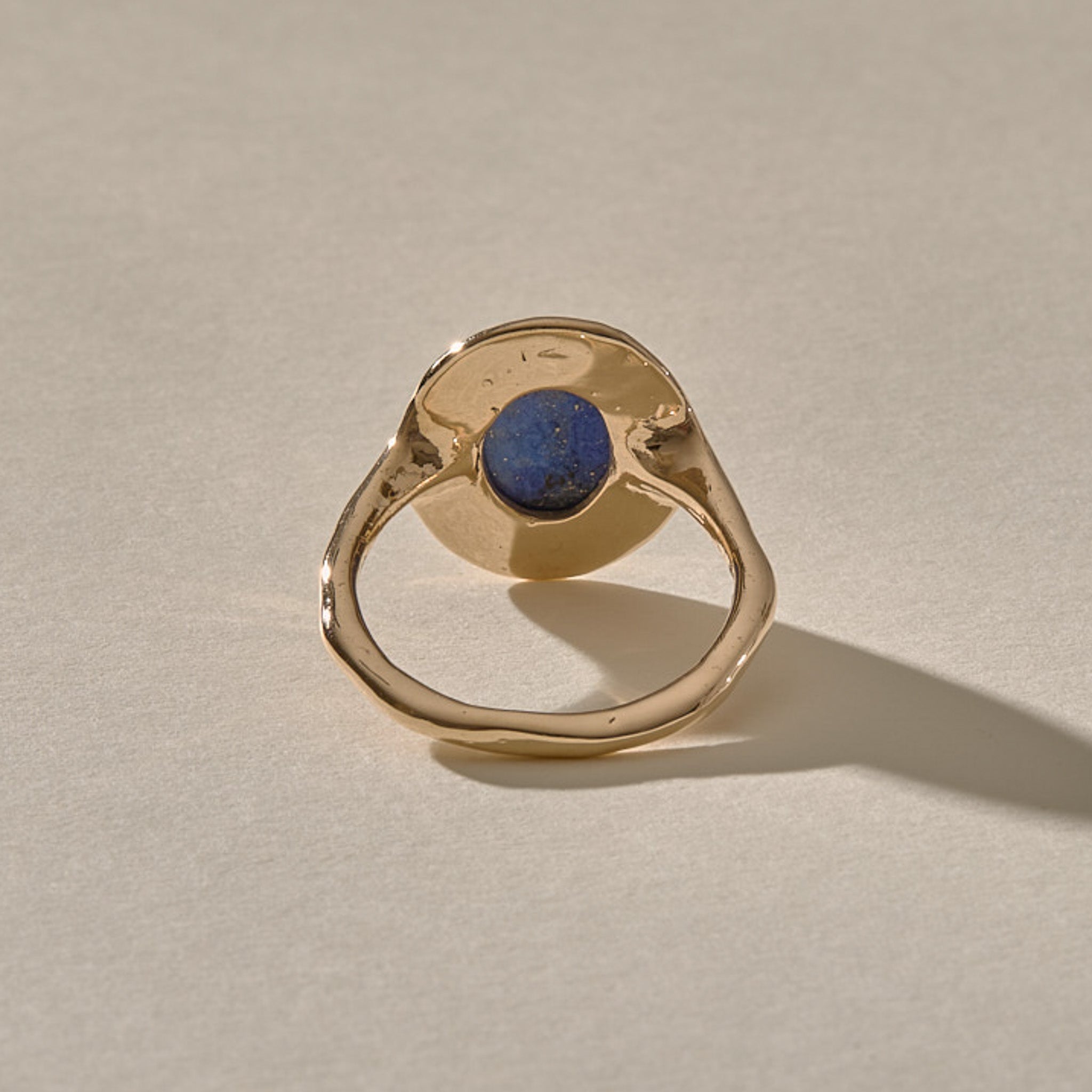 Cleo Lapis Lazuli Amulet Ring in gold from behind, showing the open back where the stone touches the skin.