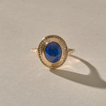 Cleo Lapis Lazuli Amulet Ring in solid recycled gold, an oval lapis lazuli cabochon in a carved gold bezel.