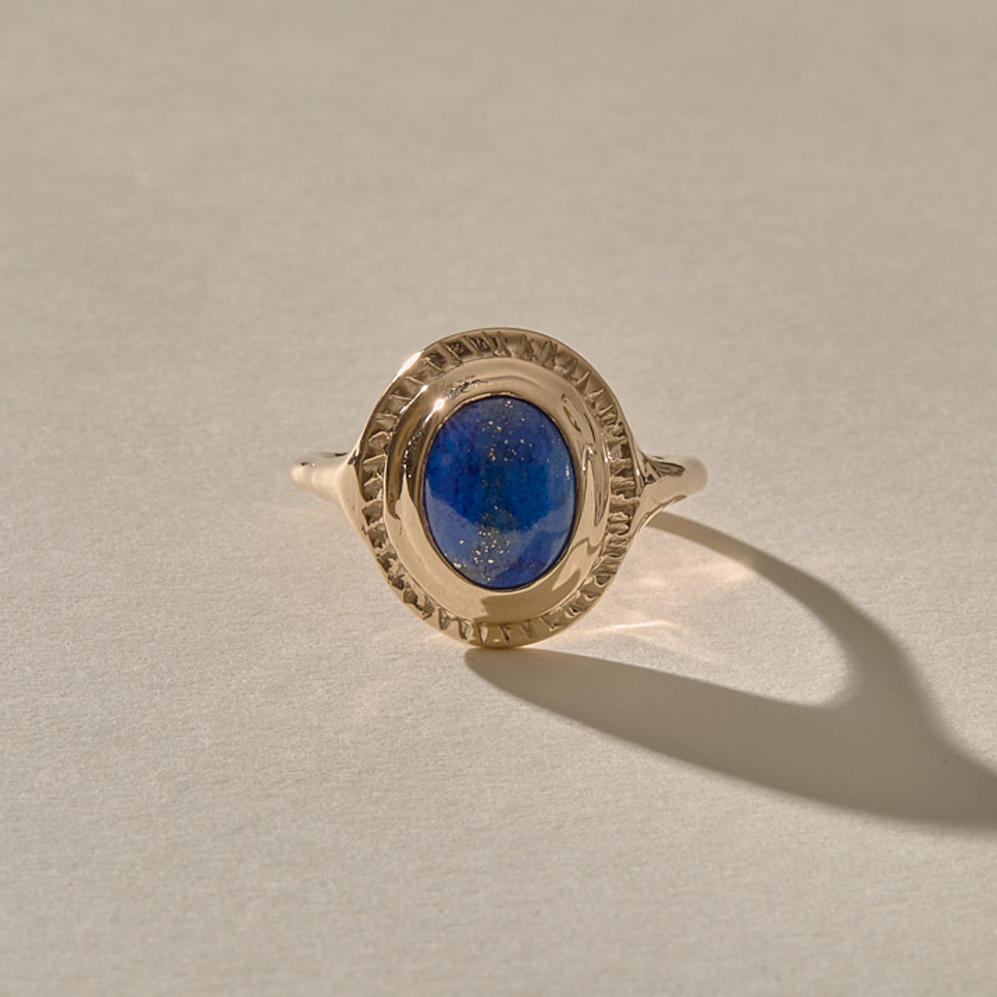 Cleo Lapis Lazuli Amulet Ring in solid recycled gold, an oval lapis lazuli cabochon in a carved gold bezel.