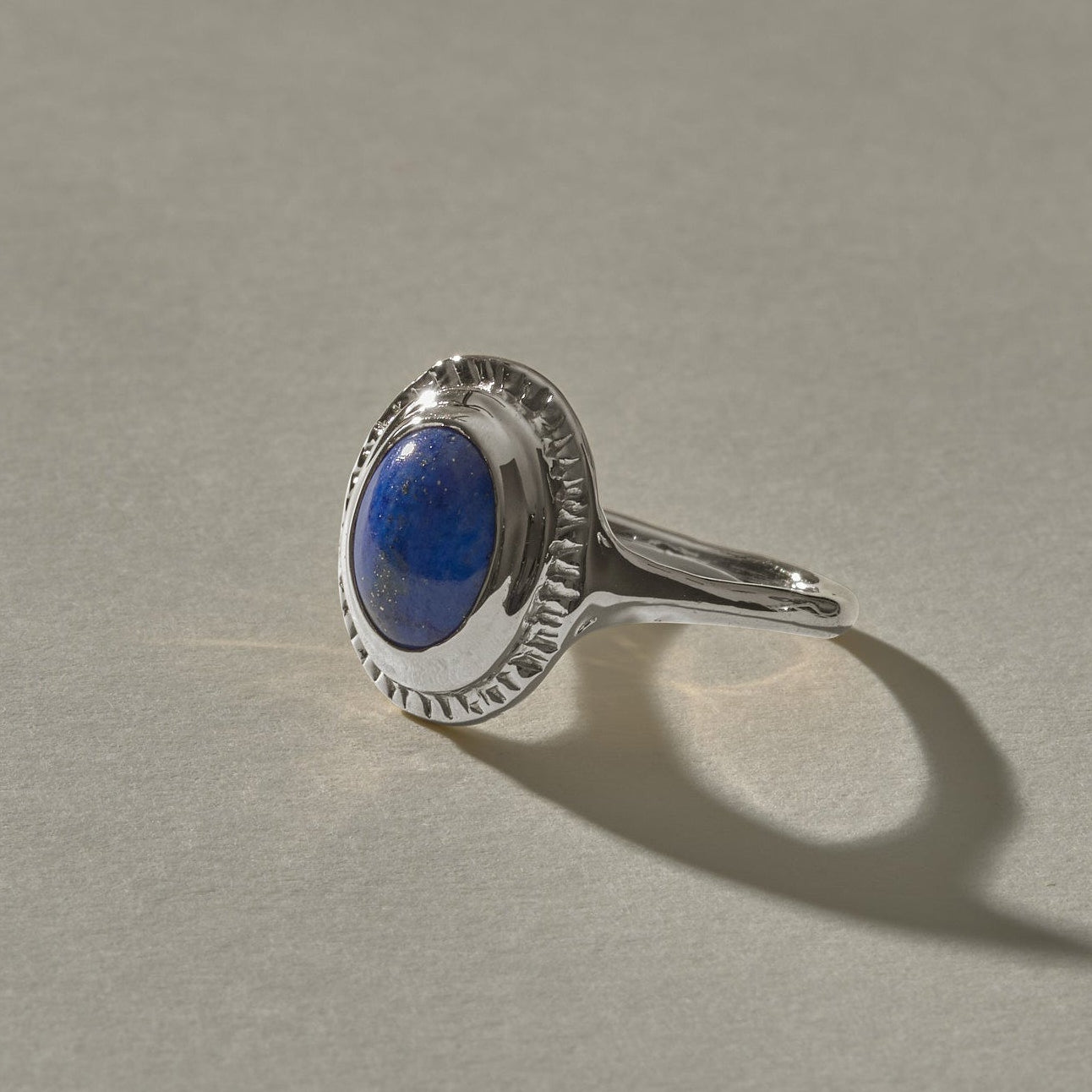 Cleo Lapis Lazuli Amulet Ring in recycled sterling silver, an oval lapis lazuli cabochon in a carved silver bezel.