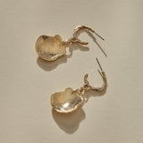 Elysian Shell Hoop Earrings in gold, both shells turned to show their smooth, cupped backs.