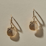 Elysian Shell Hoop Earrings in gold hanging side by side, scallop shells below small hoops.