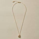 Full length of the Elysian Shell Necklace in gold on its adjustable chain.