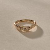 Eros Five-Stone Champagne Diamond Band in solid recycled gold at an angle, showing the graduated champagne diamonds.