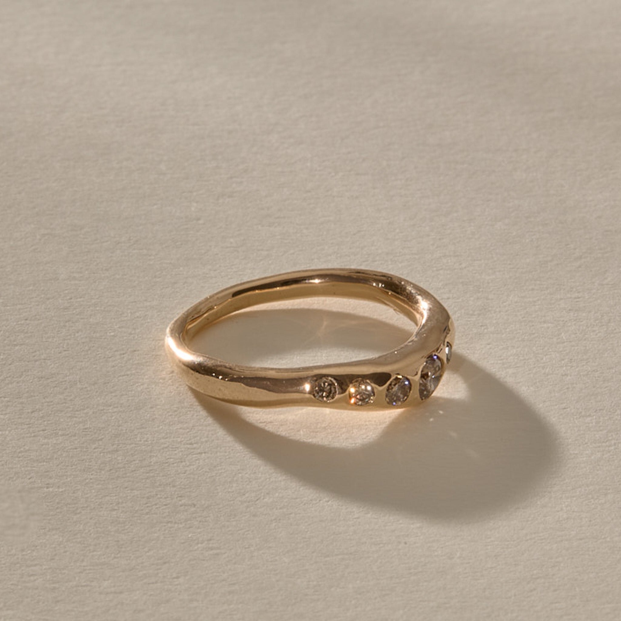 Eros Five-Stone Champagne Diamond Band in solid recycled gold from the side, showing the softly undulating band.