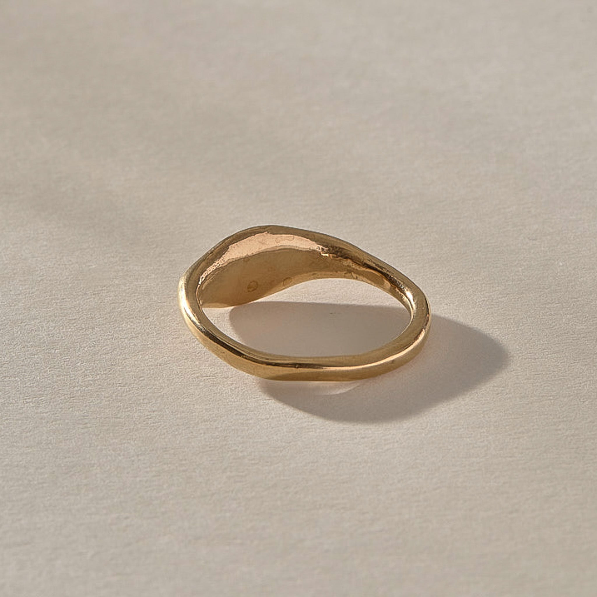 Evil Eye Protection Ring in solid recycled gold from the back at an angle, showing the tapering band.