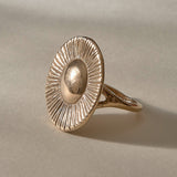 Heart of the Sun Statement Ring in recycled bronze at an angle, a domed center radiating fine carved rays.