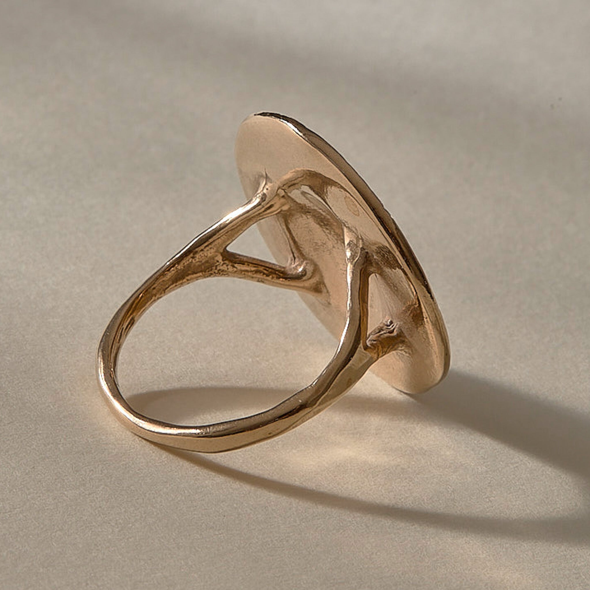 Heart of the Sun Statement Ring in recycled bronze from the back at an angle, showing the split shoulders of the band.