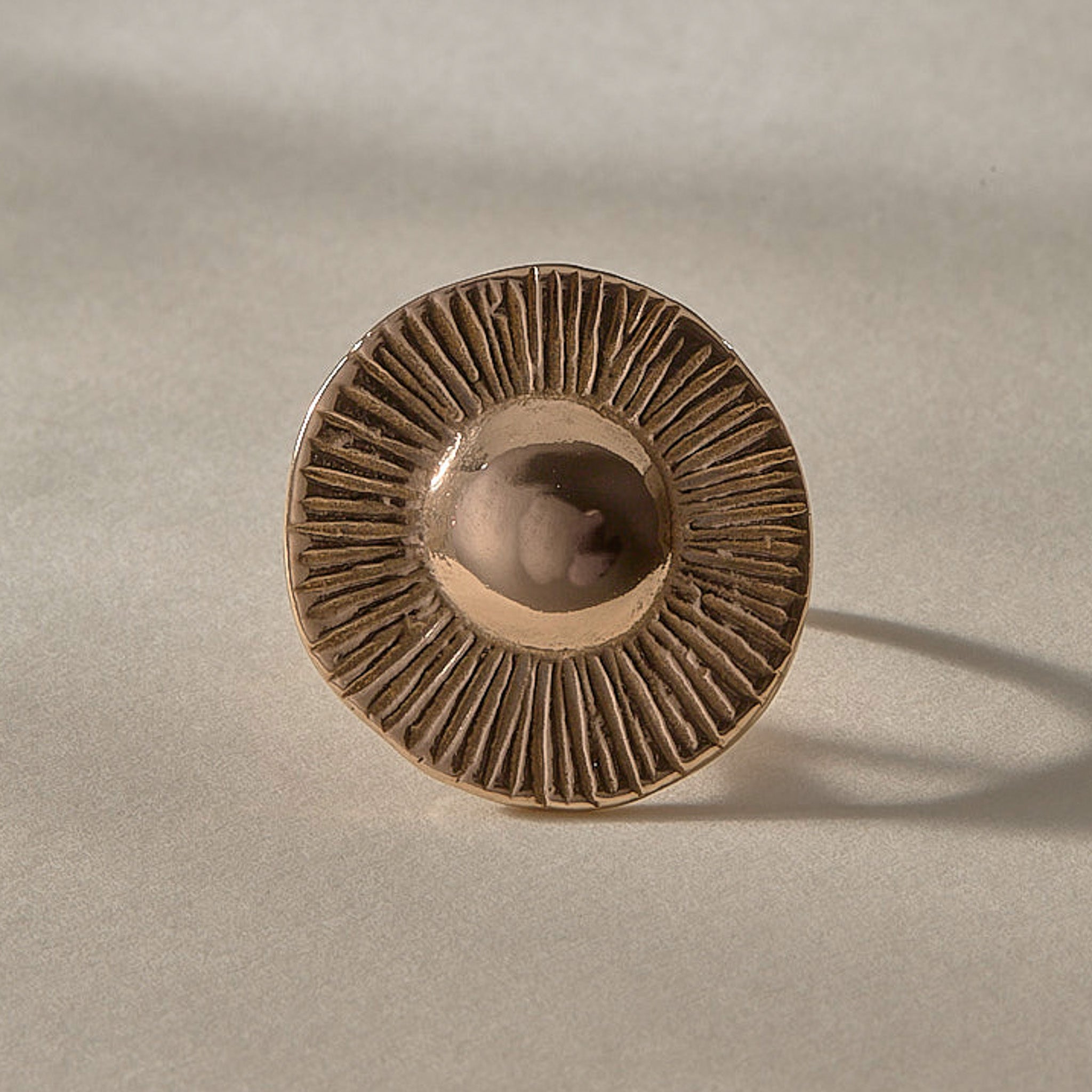 Heart of the Sun Statement Ring in recycled bronze from the front, showing the round sunburst face.