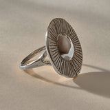 Heart of the Sun Statement Ring in recycled sterling silver from the side, showing the sunburst face and slim band.