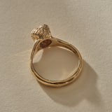 Maré Ring in solid recycled gold standing upright, shell on top