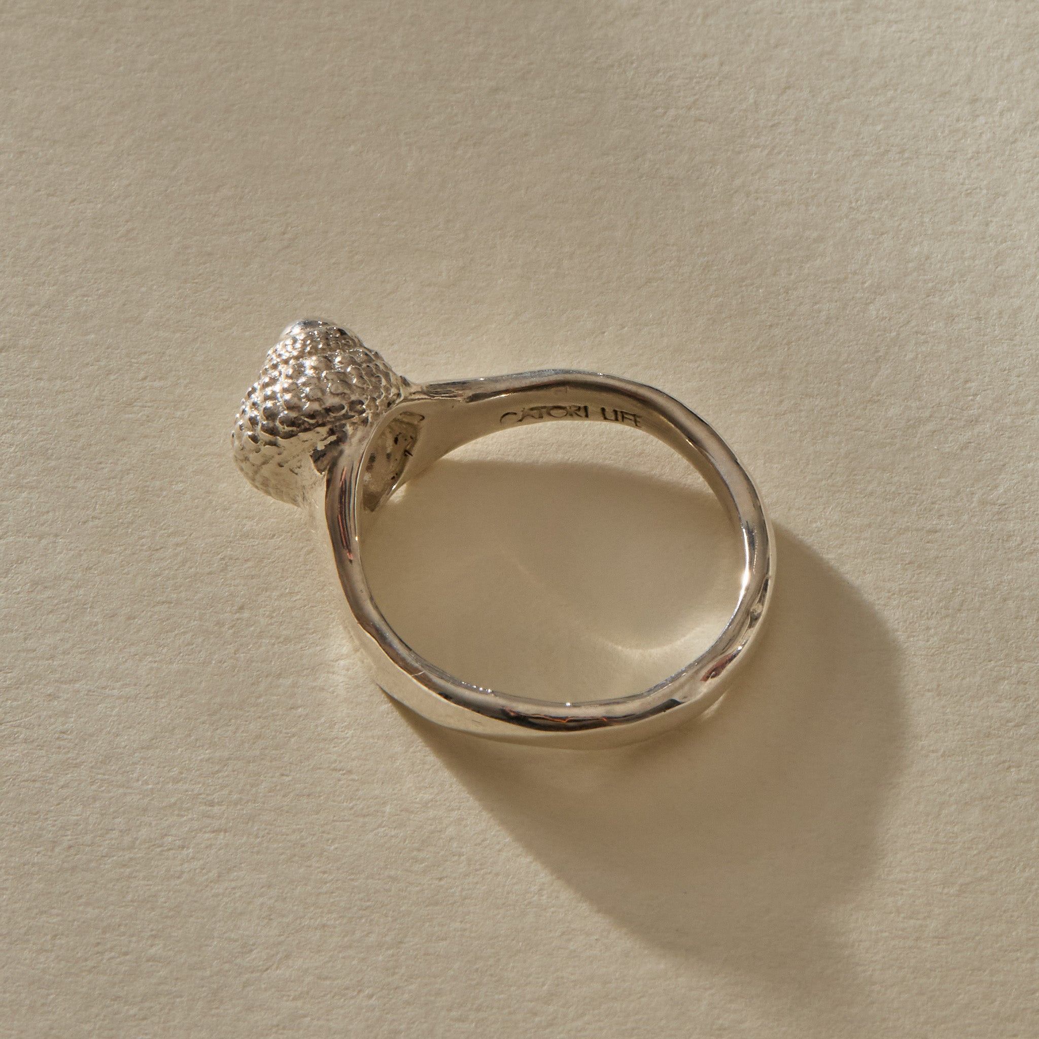 Maré Ring in recycled sterling silver standing upright, shell on top