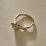 Maré Shell Ring in sterling silver from a low angle, showing the shell and the curve of the band.