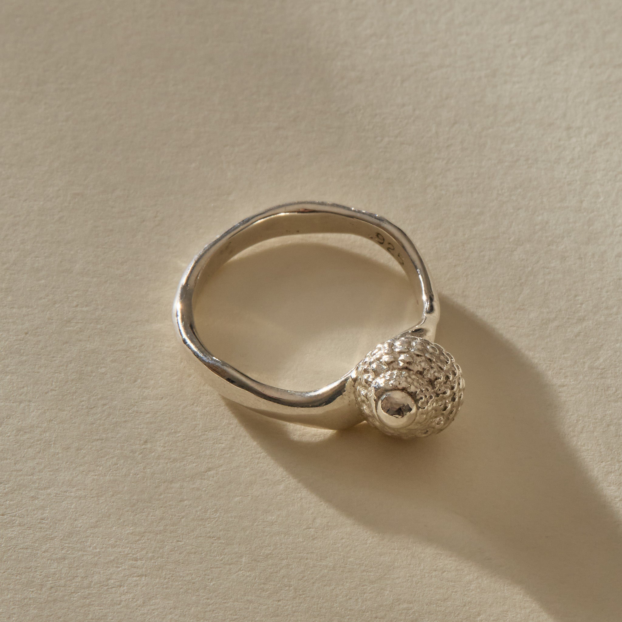 Maré Shell Ring in sterling silver at an angle, showing the textured shell and hand-formed band.
