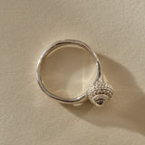 Maré Shell Ring in recycled sterling silver, a hand-cast textured seashell set to one side of an organic band.