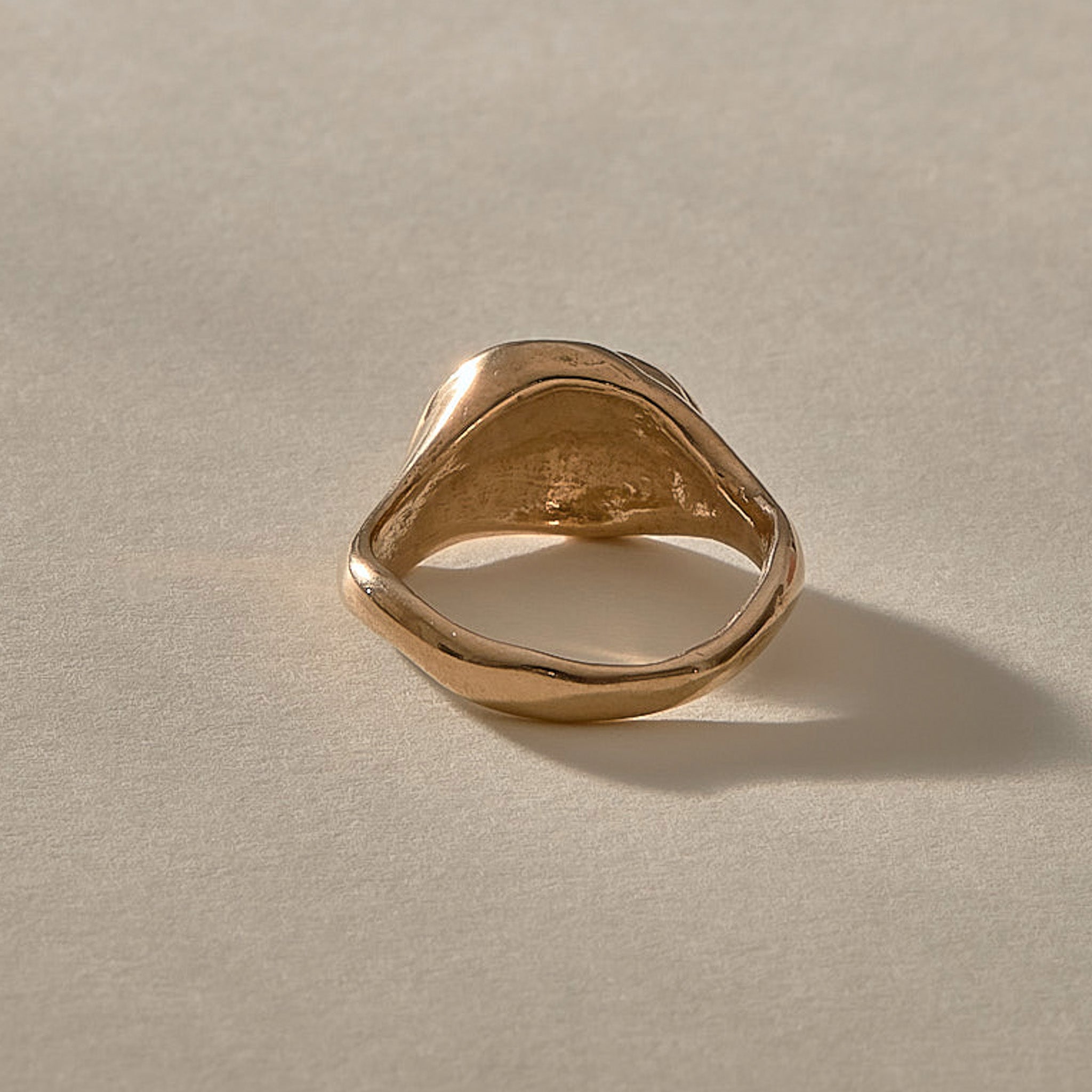 Neptune Spiral Shell Ring in bronze, the organic band seen from the side.