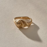 Neptune Spiral Shell Ring in gold, a hand-cast spiral seashell set on the band, seen from the front.