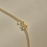 Clasp and rolo chain of the Sereia Spiral Shell Necklace in bronze.