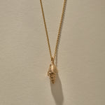 Sereia Spiral Shell Necklace in bronze, the spiral shell hanging from its chain.