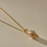 Sereia Spiral Shell Necklace in bronze, the spiral shell pendant at an angle.