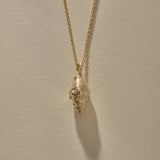 Clasp and rolo chain of the Sereia Spiral Shell Necklace in gold.