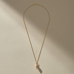 Sereia Spiral Shell Necklace in gold, a close view of the ridged spiral shell.