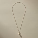 Full length of the Sereia Spiral Shell Necklace in sterling silver on its 20 inch chain.