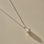 Sereia Spiral Shell Necklace in sterling silver, the spiral shell pendant at an angle.