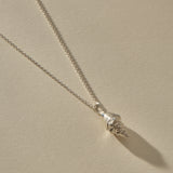Sereia Spiral Shell Necklace in sterling silver, the spiral shell pendant at an angle.