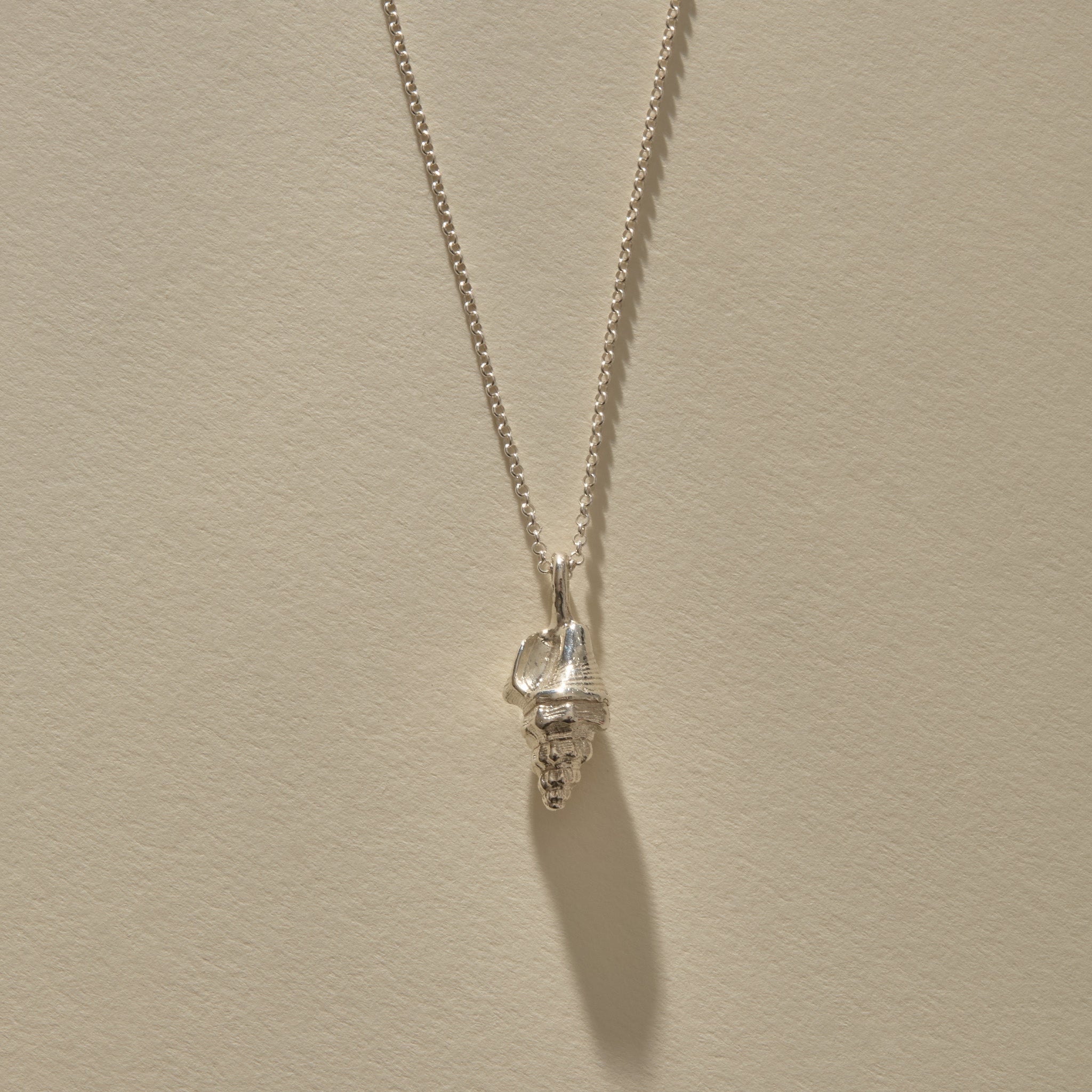 Sereia Spiral Shell Necklace in recycled sterling silver, a cast spiral seashell pendant on a fine rolo chain.