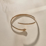 Serpent Snake Arm Cuff in bronze at an angle, showing the coiled, open design.