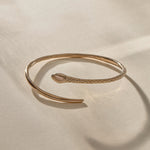 Serpent Snake Arm Cuff in recycled bronze, hand-carved with a detailed snake head and scales.